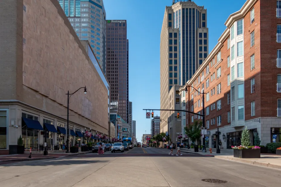 Broad street in downtown Columbus, Ohio with two pedestrians in crosswalk